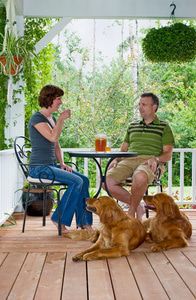 Family relaxing and enjoying quality time on their porch with some iced tea